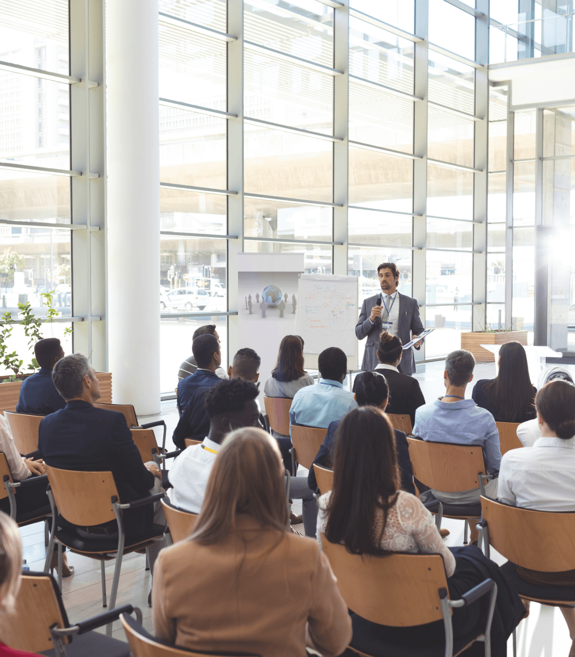 A man presenting to a group of people, showcasing the Company 360 Panel, a streamlined data management solution for businesses.