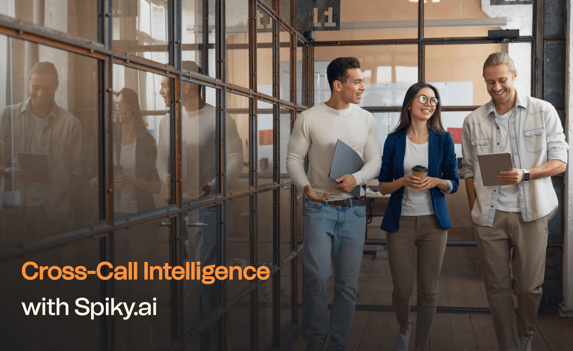 Three colleagues walking and talking in a modern office hallway, smiling and holding laptops and coffee cups — Cross-Call Intelligence with Spiky.ai