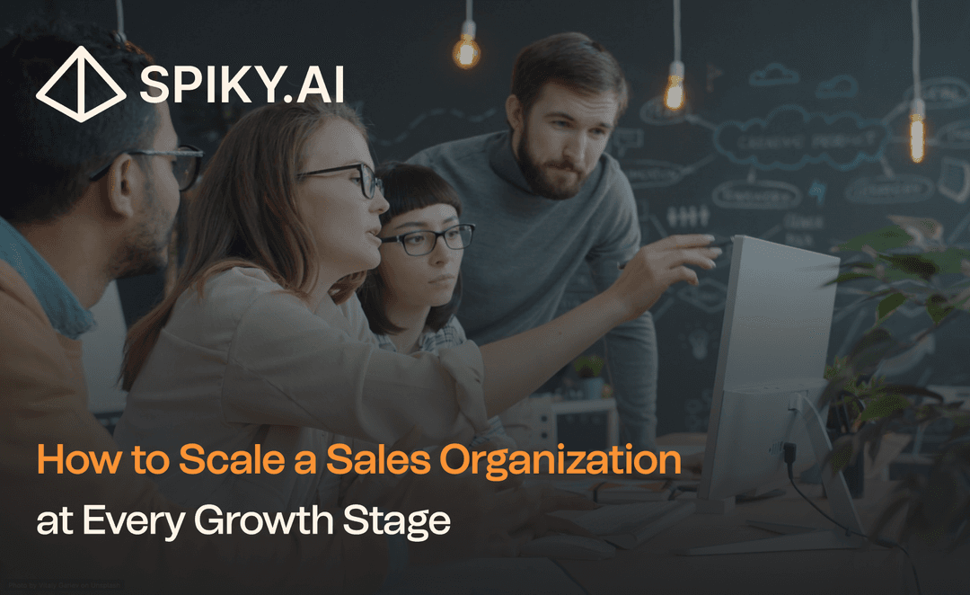 A diverse sales team collaborates around a desktop computer in a modern office, with chalkboard sketches and text about scaling growth.