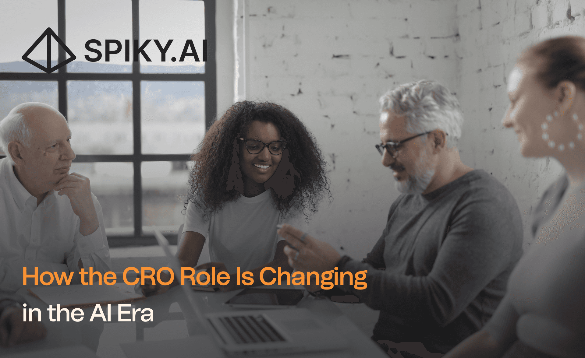Business leaders in a meeting discussing revenue strategy, featured in Spiky.AI’s ‘How the CRO Role Is Changing in the AI Era
